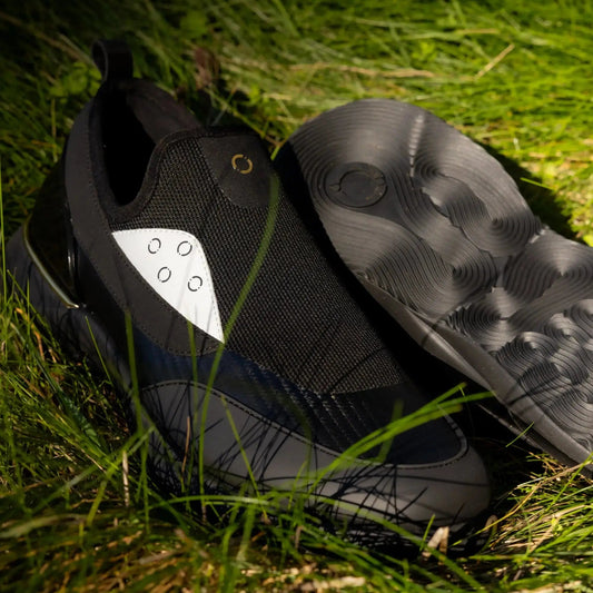 Snogs Genesis Night Shift sneakers on grass showing the slip-resistant outsole tread