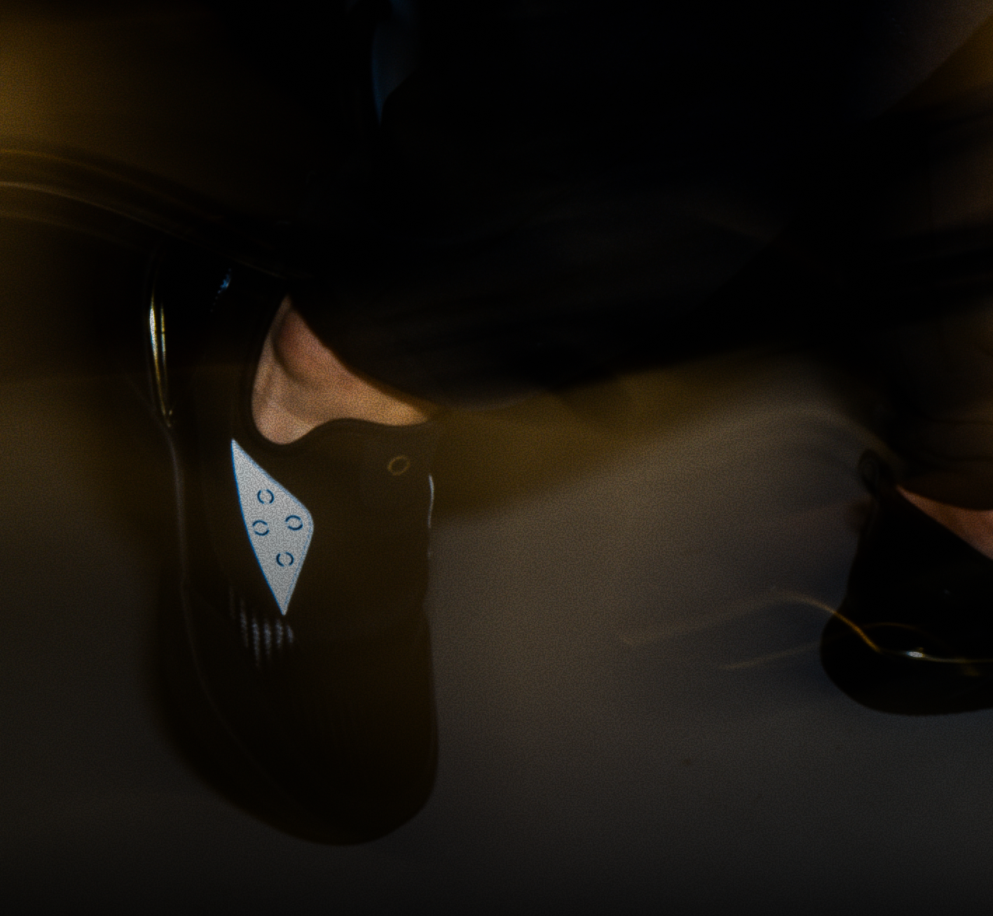 A person wearing white Snogs Dayshift shoes in a medical environment.