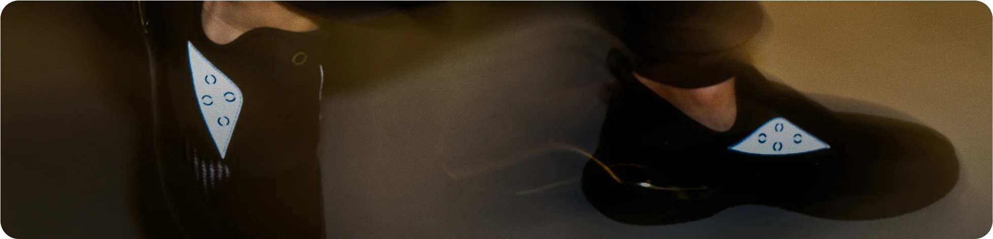 A close-up, motion-blurred shot of Snogs Nightshift footwear being worn.