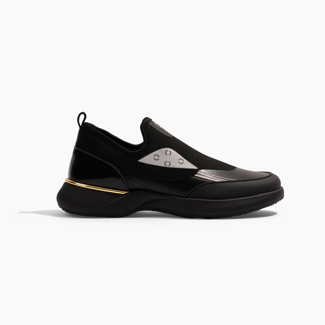 Snogs Genesis Night Shift black slip-on sneaker with gold accent stripe, side view
