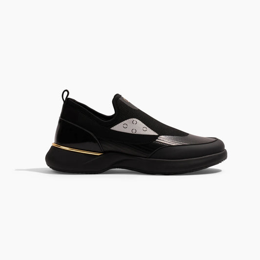Snogs Genesis Night Shift black slip-on sneaker with gold accent stripe, side view